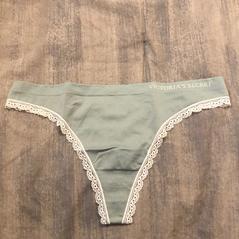 Victoria’s Secret stretch thong. New without tags. Light gray with pink lace. Lg